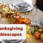 Thanksgiving Tablescape with lights, plate settings, and apples displayed on a table.