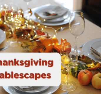 Thanksgiving Tablescape with lights, plate settings, and apples displayed on a table.