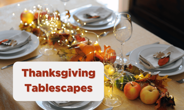 Thanksgiving Tablescape with lights, plate settings, and apples displayed on a table.