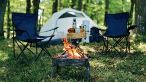 Photo of camp site with two folding chairs and fire