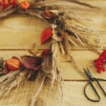 Blog - DIY Fall Decor Image. Pinecone, leaves, scissors, etc on a table.