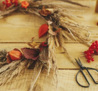 Blog - DIY Fall Decor Image. Pinecone, leaves, scissors, etc on a table.